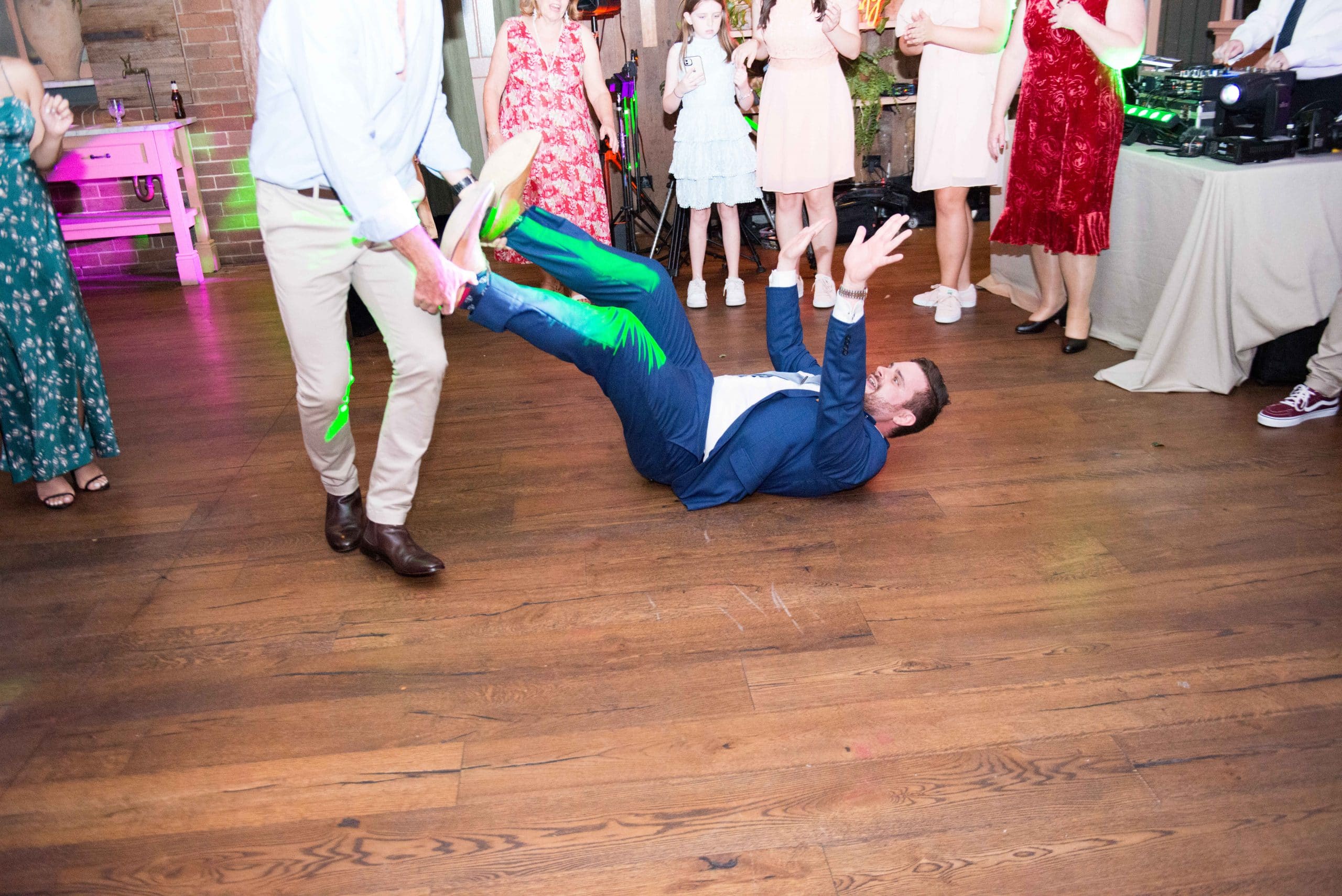 Nathan being dragged on the floor by his legs on the dancefloor