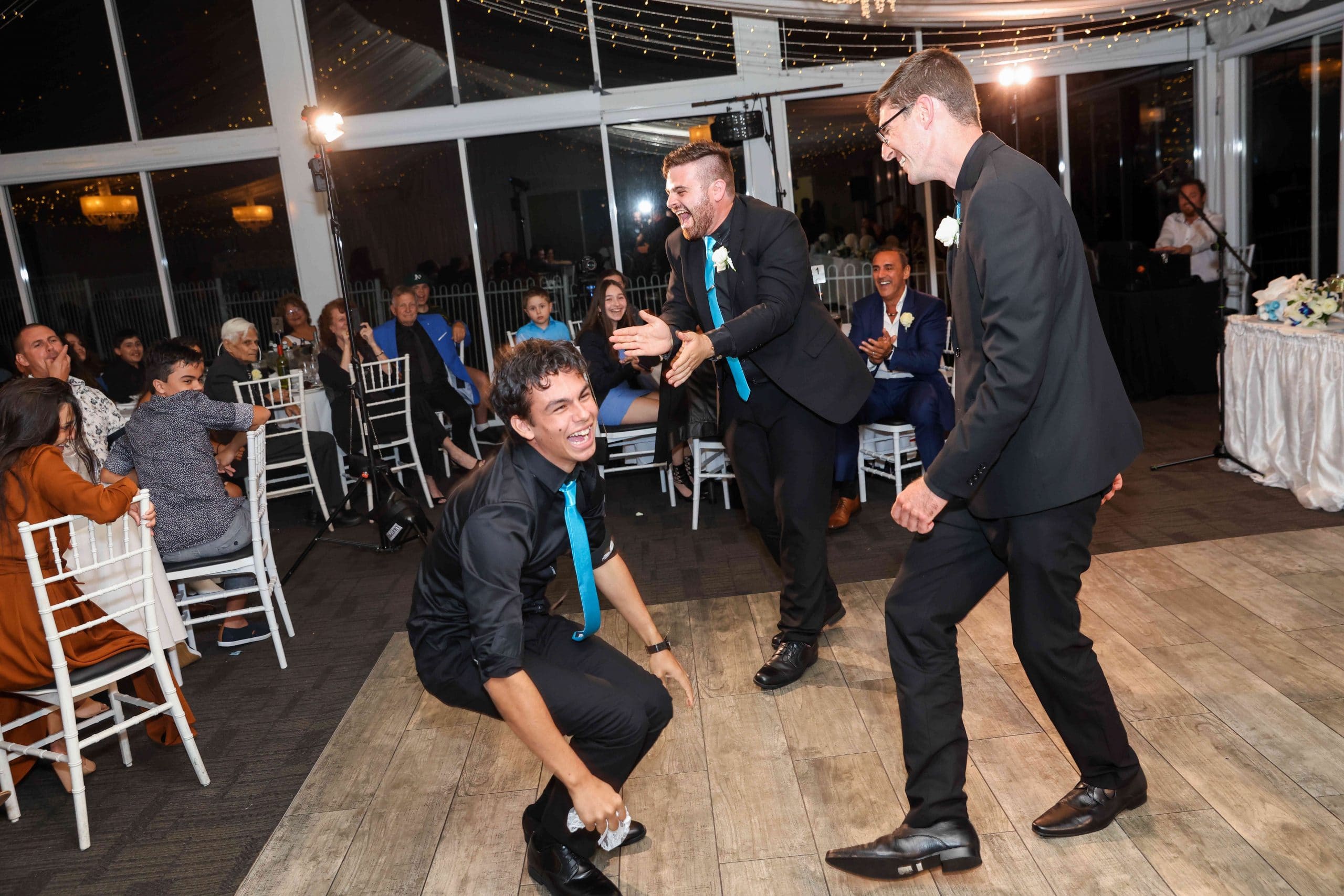 Nathan Cassar laughing with two other men n the dancefloor