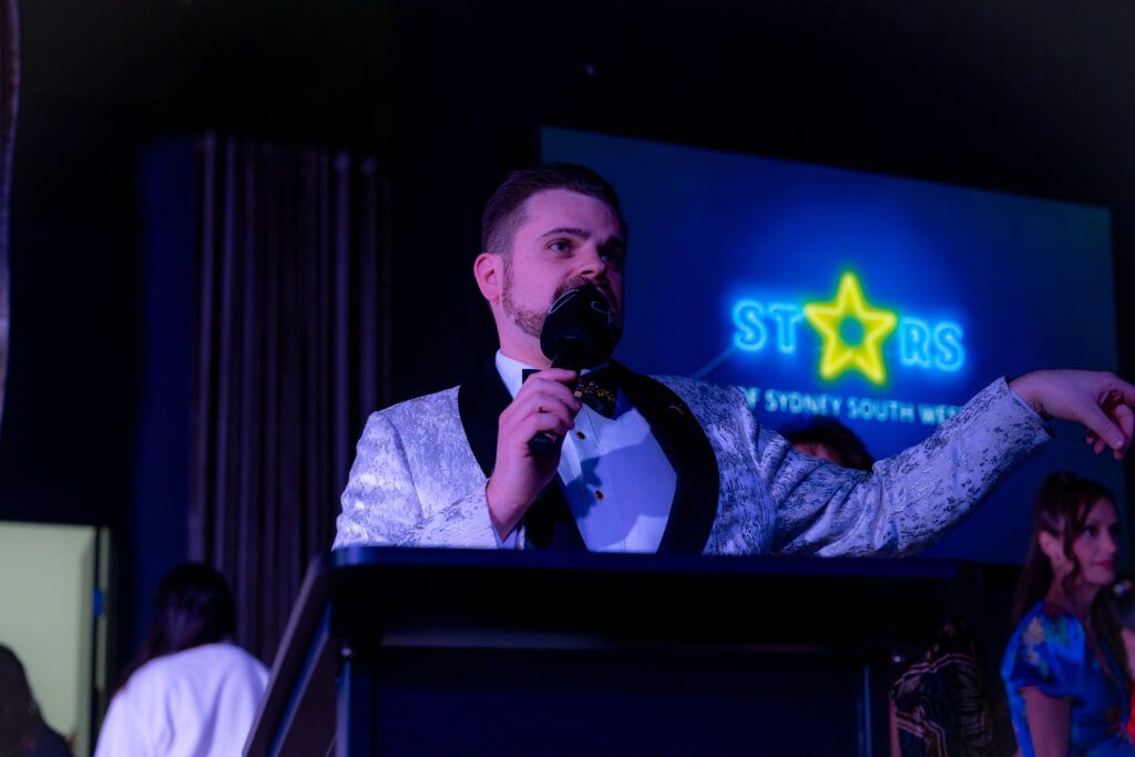 Nathan Cassar performing as MC at the Cancer Council Stars of Sydney South West 2024 event