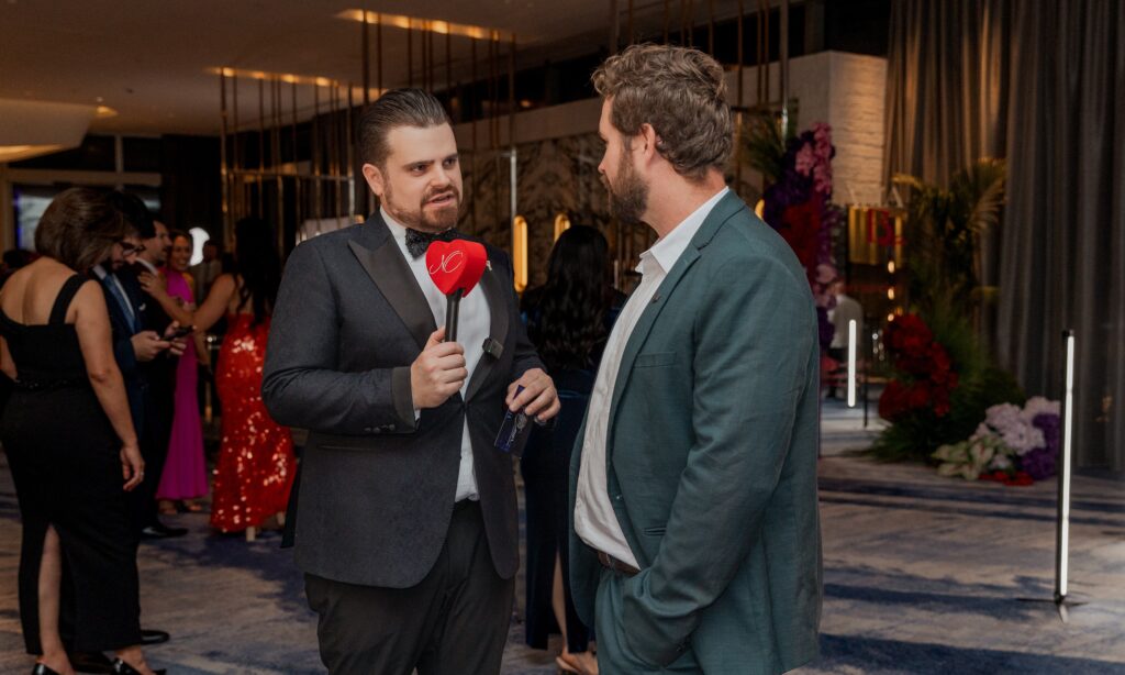 Nathan Cassar, corporate event mc speaking with guest at formal gala event