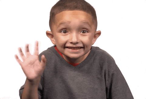 Little boy smiling and waving rapidly with his right hand