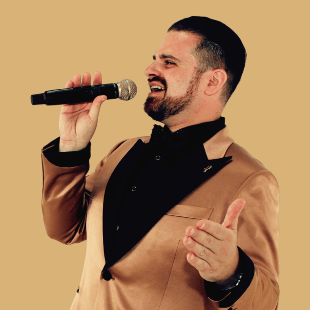 Nathan Cassar, corporate event mc singer performing with microphone in tan suit