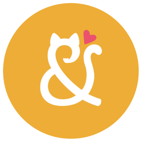 White cat-shaped ampersand with pink heart on mustard circle
